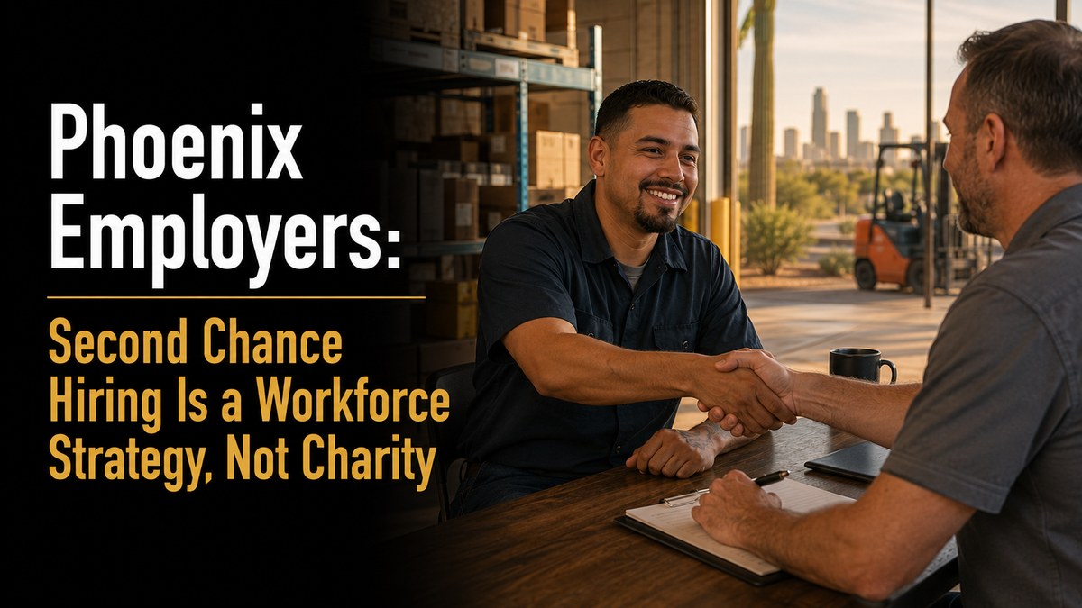 Two people shaking hands in a bright Phoenix warehouse or workshop